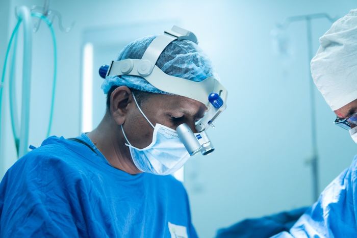 Surgeon with loupes, focused